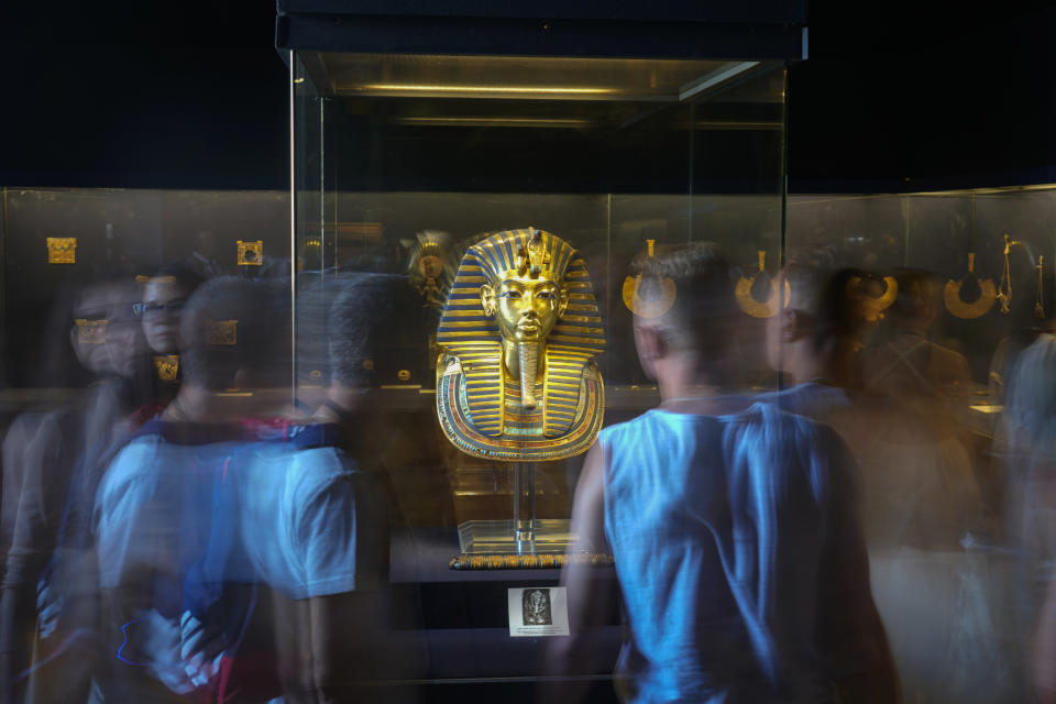 Tourists surround the golden mask of King Tutankhamun at the Egyptian Museum in Cairo, Egypt, Wednesday, Sept. 27, 2023. Egypt is aiming at reaching 30 million visitors by 2028, as its once-thriving tourism sector has begun to recover from the fallout of the coronavirus pandemic and the grinding war in Europe, Egypt's Tourism and Antiquities Minister Ahmed Issa said during an interview with the Associated Press. (AP Photo/Amr Nabil)