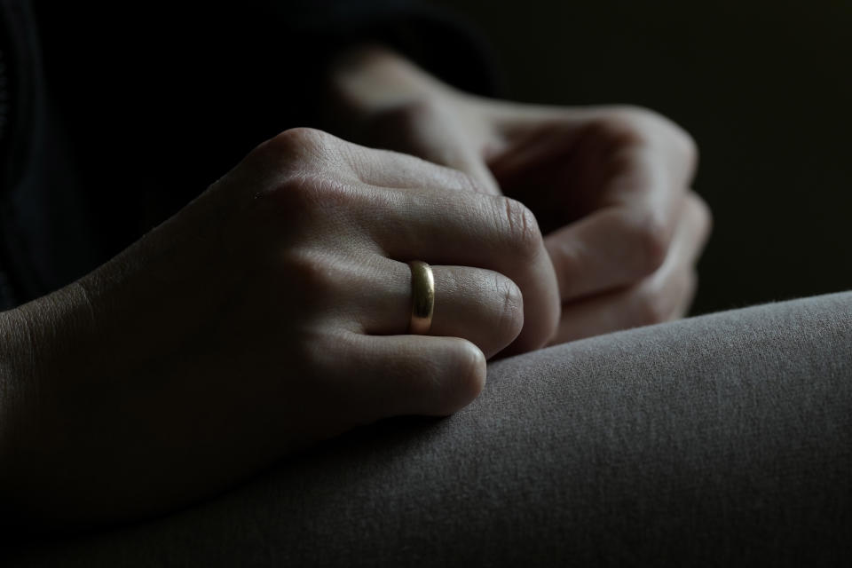 The hands of Viktoria Kovalenko show the wedding ring as she speaks to The Associated Press during an interview at her home in a village in Kent, Thursday, Feb. 9, 2023. Kovalenko chose to come to England not only because it offered her refuge from the war in Ukraine. It was also a chance for her to escape from her harrowing memories of losing her family in a shell attack. (AP Photo/Frank Augstein)