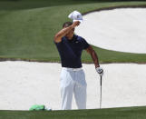 Tiger Woods pauses while getting in some work chipping at the practice range before his practice round for the Masters at Augusta National Golf Club in Augusta, Ga., Monday, April 4, 2022. (Curtis Compton /Atlanta Journal-Constitution via AP)