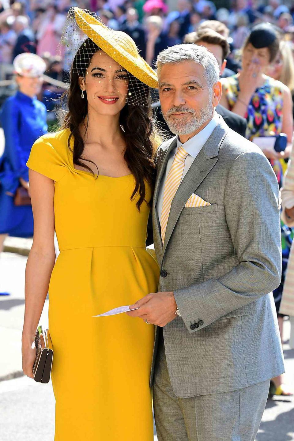 Amal and George Clooney arrive at St George's Chapel at Windsor Castle before the wedding of Prince Harry to Meghan Markle on May 19, 2018 in Windsor, England