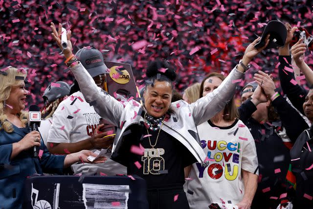 <p>Gregory Shamus/Getty </p> Head coach Dawn Staley of the South Carolina Gamecocks celebrates after beating the Iowa Hawkeyes in the 2024 NCAA Women's Basketball Tournament National Championship at Rocket Mortgage FieldHouse on April 07, 2024 in Cleveland, Ohio. South Carolina beat Iowa 87-75