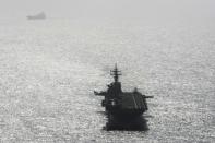 USS Boxer (LHD-4) ship sails near a tanker in the Arabian Sea off Oman