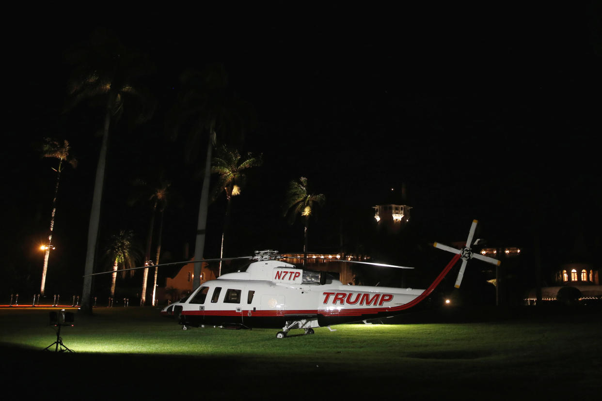 A Trump-branded helicopter sits on the lawn to greet guests as they arrive for a New Year's Eve party at Mar-a-lago in 2016. (Jonathan Ernst/Reuters)