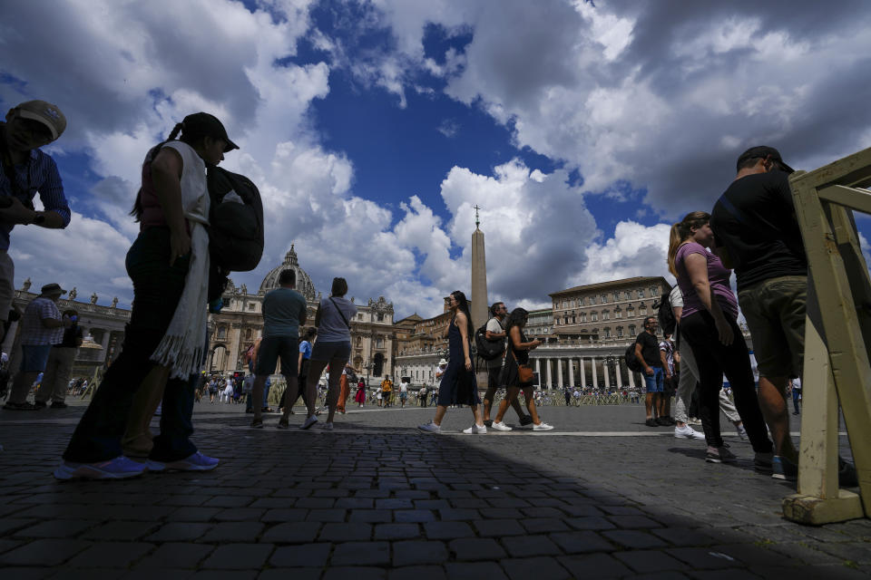 Tourists and faithful wander in St. Peter's Square at noon,Sunday, June 11, 2023. Pope Francis, following doctors' advice, skipped Sunday's customary public blessing to allow him to better heal after abdominal surgery. (AP Photo/Alessandra Tarantino)