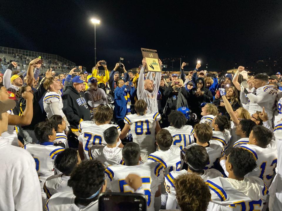 Casey Maholchic hoisting the CIF-Southern Section Division 8 championship plaque.