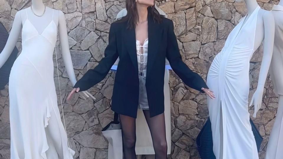 Alexa Chung wearing a black blazer and silk shorts