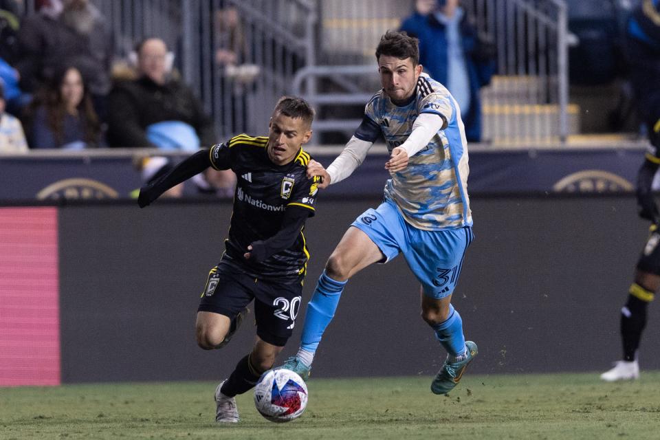 Union midfielder Leon Maximilian Flach and Crew midfielder Alex Matan battle for the ball.