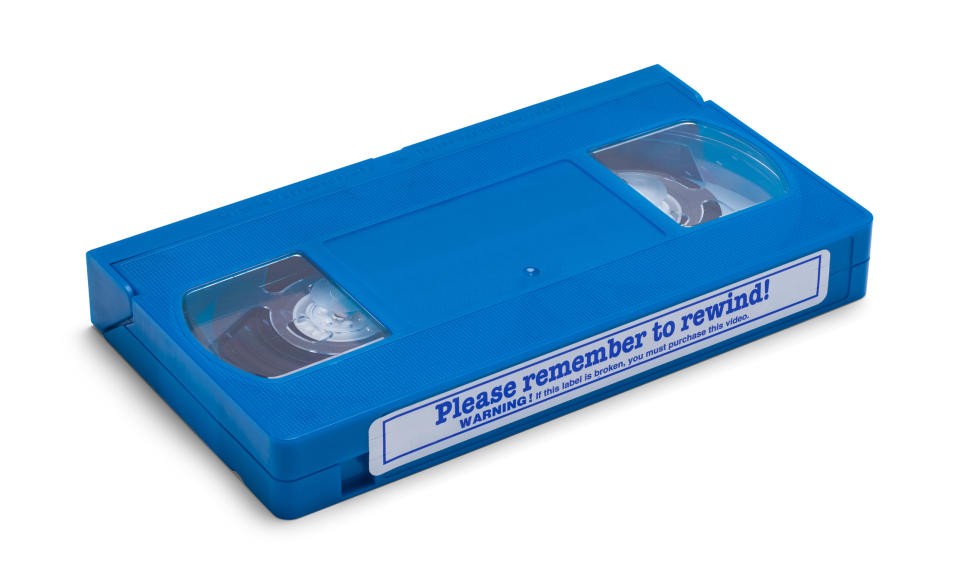 Blue VHS tape with a label urging to "please remember to rewind."