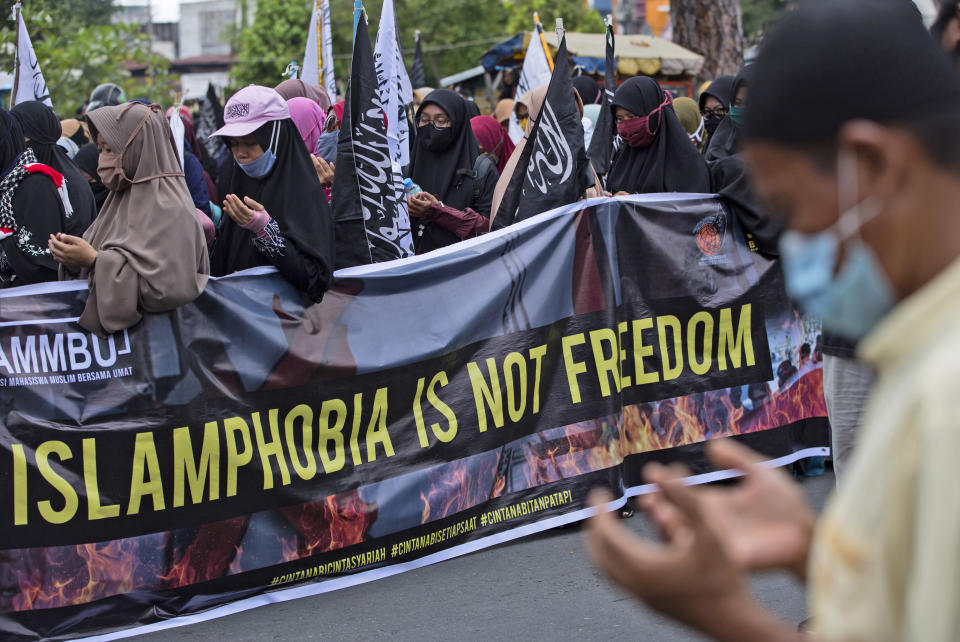 Indonesian Muslims pray during an anti-France rally outside Al Mashun Great Mosque in Medan, North Sumatra, Indonesia, Saturday, Oct. 31, 2020. Muslims around the world have been calling for both protests and a boycott of French goods in response to France's stance on caricatures of Islam's most revered prophet. (AP Photo/Binsar Bakkara)