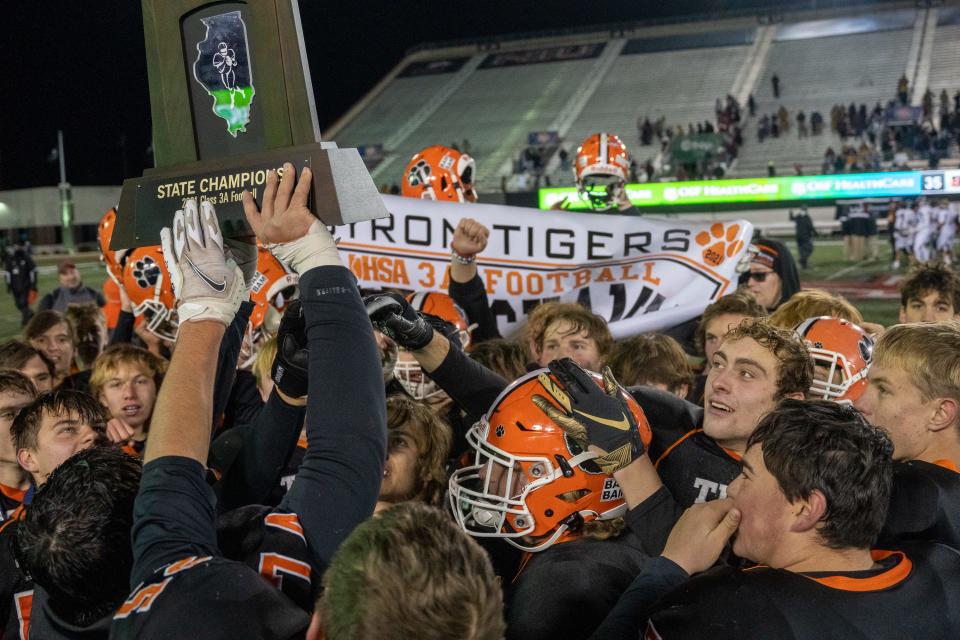 The Byron football team celebrates after winning the Class 3A state championship game on Friday, November 26, 2021 at Huskie Stadium in DeKalb.