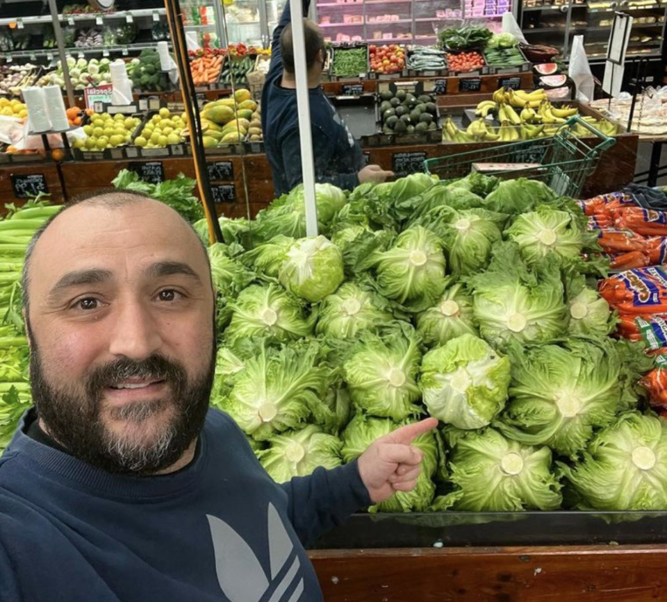 Adelaide grocer Johnny Kapiris in front of a lettuce stand