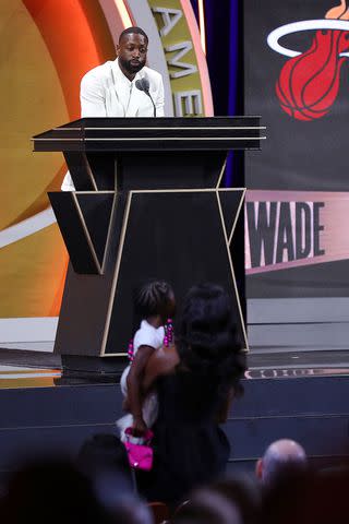 <p>Mike Lawrie/Getty</p> Dwyane Wade speaks to Gabrielle Union at 2023 Naismith Basketball Hall of Fame Induction