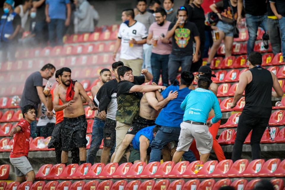Fans clash during a Liga MX match between Queretaro and Atlas (Sergio Gonzalez/AP) (AP)