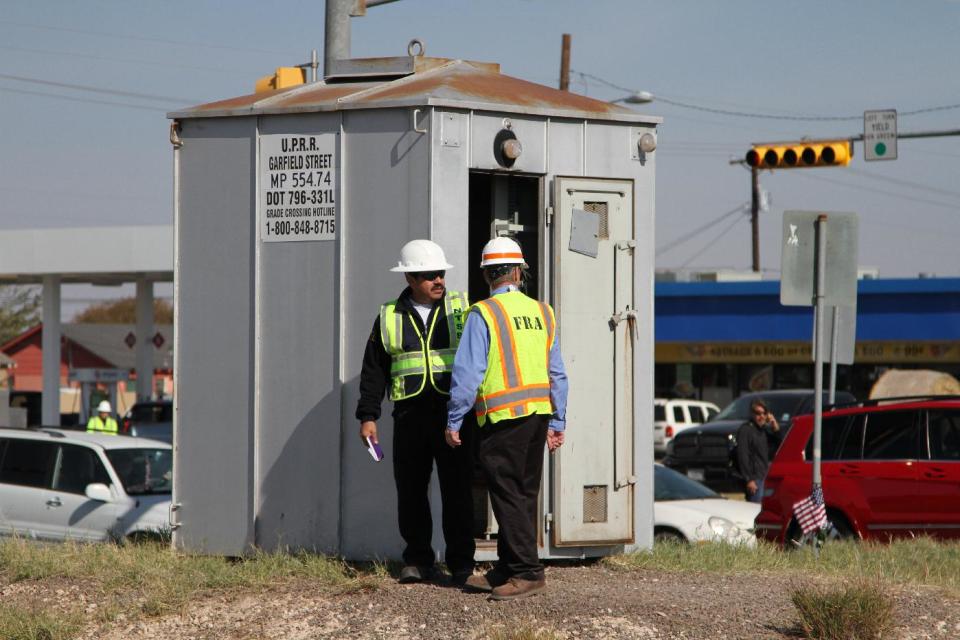 Railroad investigators work the scene of an accident where four veterans were killed and 16 other people were injured when a train slammed into a parade float carrying the returning heroes to a banquet last Thursday in Midland, Texas on Saturday, Nov. 17, 2012. Federal investigators were trying to determine whether the two-float parade had been given enough warning to clear the tracks. (AP Photo/Juan Carlos Llorca)