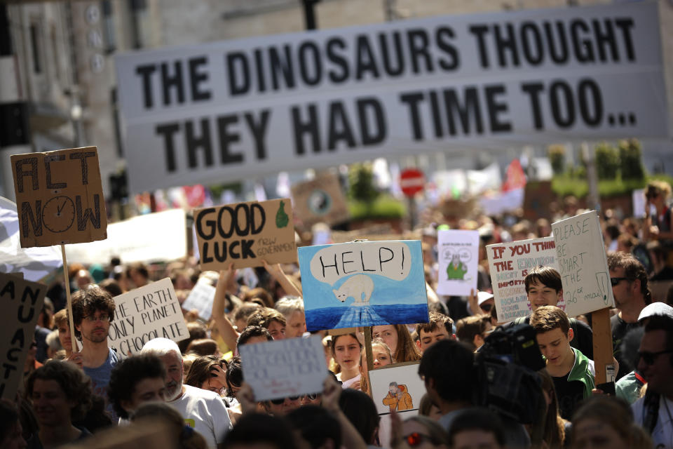 People march during a climate protest in Brussels, Friday, May 24, 2019. Protesters are holding rallies in several European Union countries to demand tougher action against global warming, as the 28-nation bloc votes to fill the European Parliament. (AP Photo/Francisco Seco)