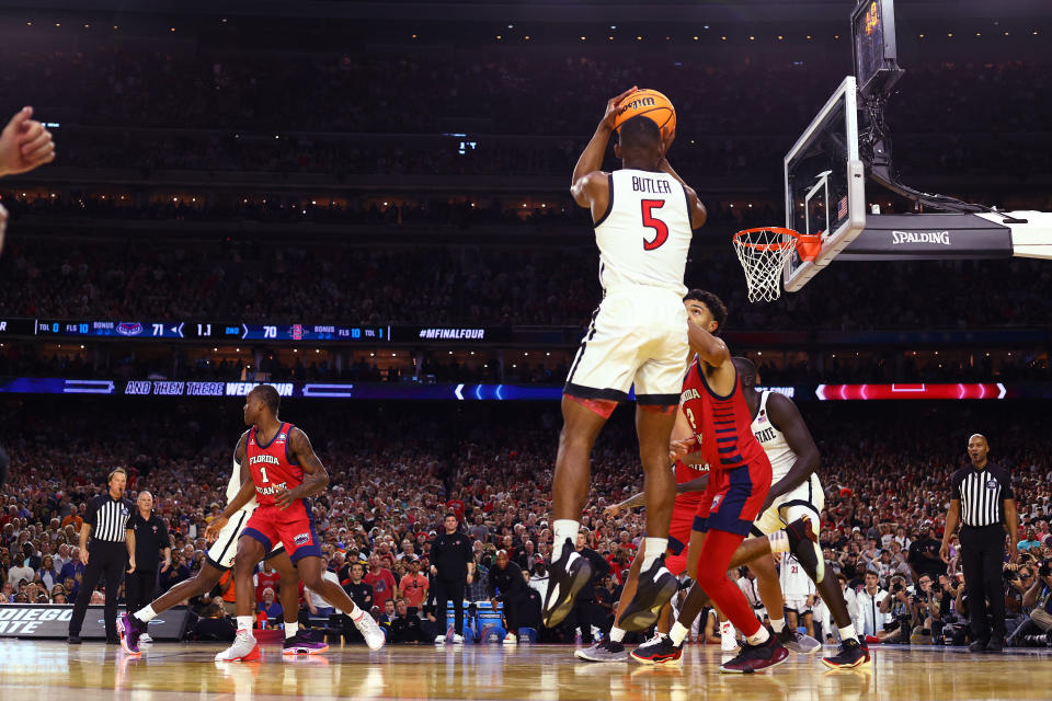 HOUSTON, TEXAS - APRIL 01: (EDITORS NOTE: In this photo taken with a remote camera) Lamont Butler #5 of the San Diego State Aztecs shoots the ball to win the game against the Florida Atlantic Owls during the NCAA Men’s Basketball Tournament Final Four semifinal game at NRG Stadium on April 01, 2023 in Houston, Texas. (Photo by Jamie Schwaberow/NCAA Photos via Getty Images)