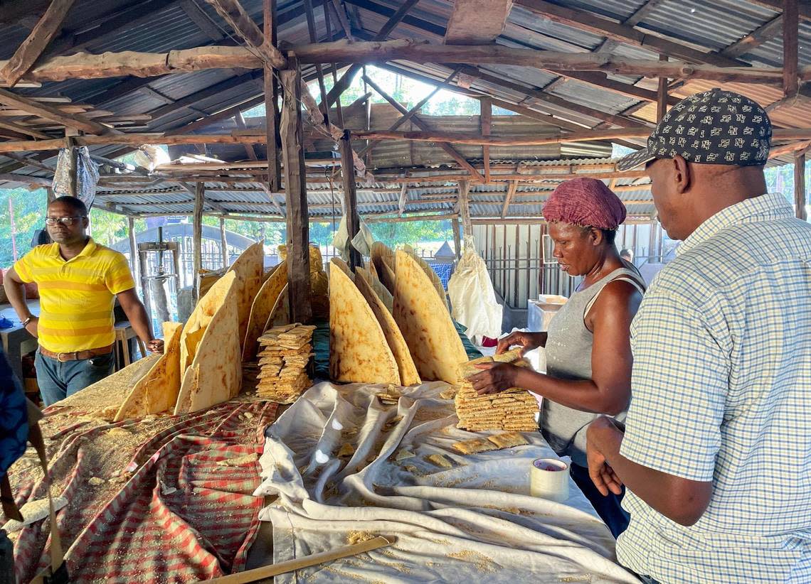 Monarc Petit Benoit, in yellow shirt, decided to invest in a cassava business in Haiti’s second largest city. The food staple has grown in popularity amid rising food prices and the COVID-19 pandemic. Haiti recently joined Cuba, the Dominican Republic, Honduras and Venezuela in seeking recognition from UNESCO for the popular flatbread known as casabe or kasav, which is still made the same way it was centuries ago, by hand.