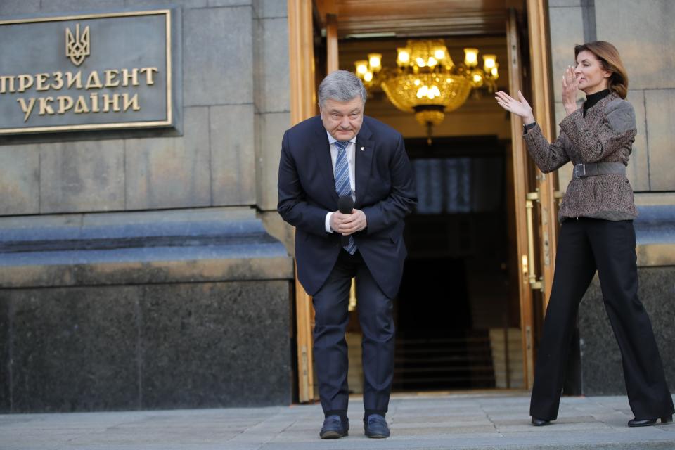 Ukrainian President Petro Poroshenko bow to the people as his wife Maryna applauds while they greet their supporters who have come to thank him for what he did as a president, in Kiev, Ukraine, Monday, April 22, 2019. Political mandates don't get much more powerful than the one Ukrainian voters gave comedian Volodymyr Zelenskiy, who as president-elect faces daunting challenges along with an overwhelming directive to produce change. (AP Photo/Vadim Ghirda)