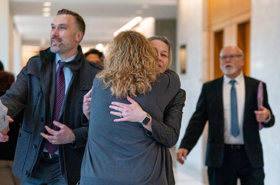 Lori Kennedy, Joy Hibb's aunt, hugs Angie Hibbs, Joy's daughter, center, alongside her brother, David Hibbs, left, and father, Charlie Hibbs, right, just before the trial of Robert Atkins at the Bucks County Justice Center in Doylestown on Monday, Jan. 29, 2024.

Daniella Heminghaus | Bucks County Courier Times