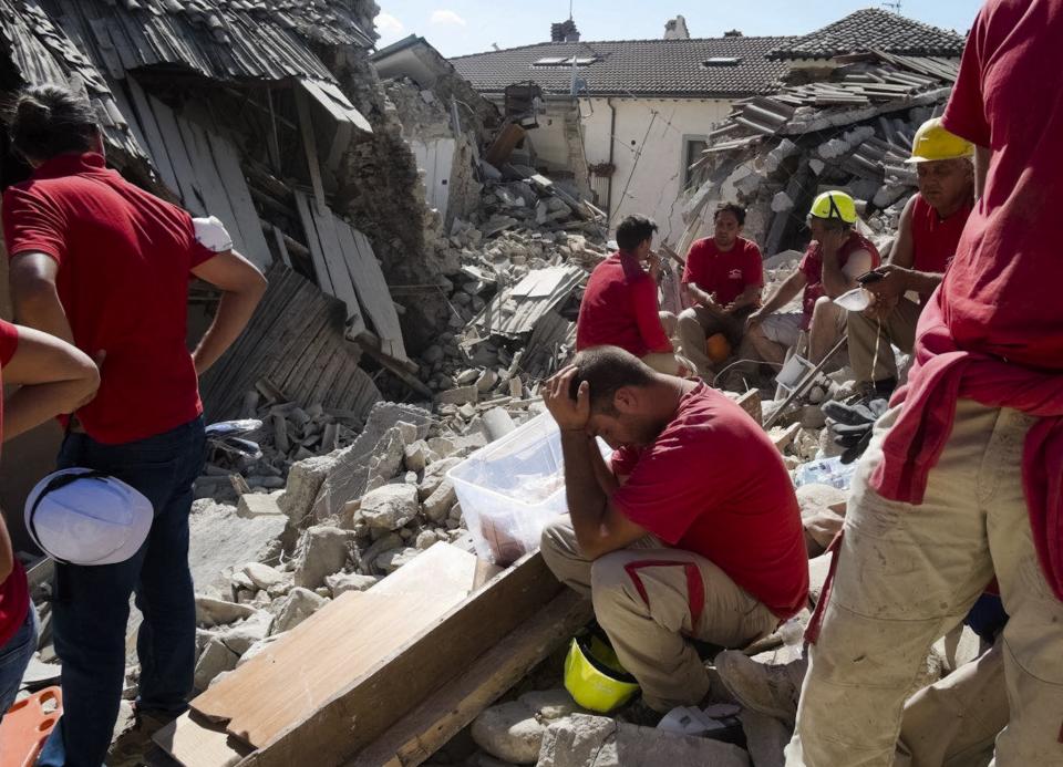 <p>Rescuers pause in Amatrice, central Italy, where a 6.1 earthquake struck just after 3:30 a.m., Wednesday, Aug. 24, 2016. (AP Photo/Emilio Fraile) </p>