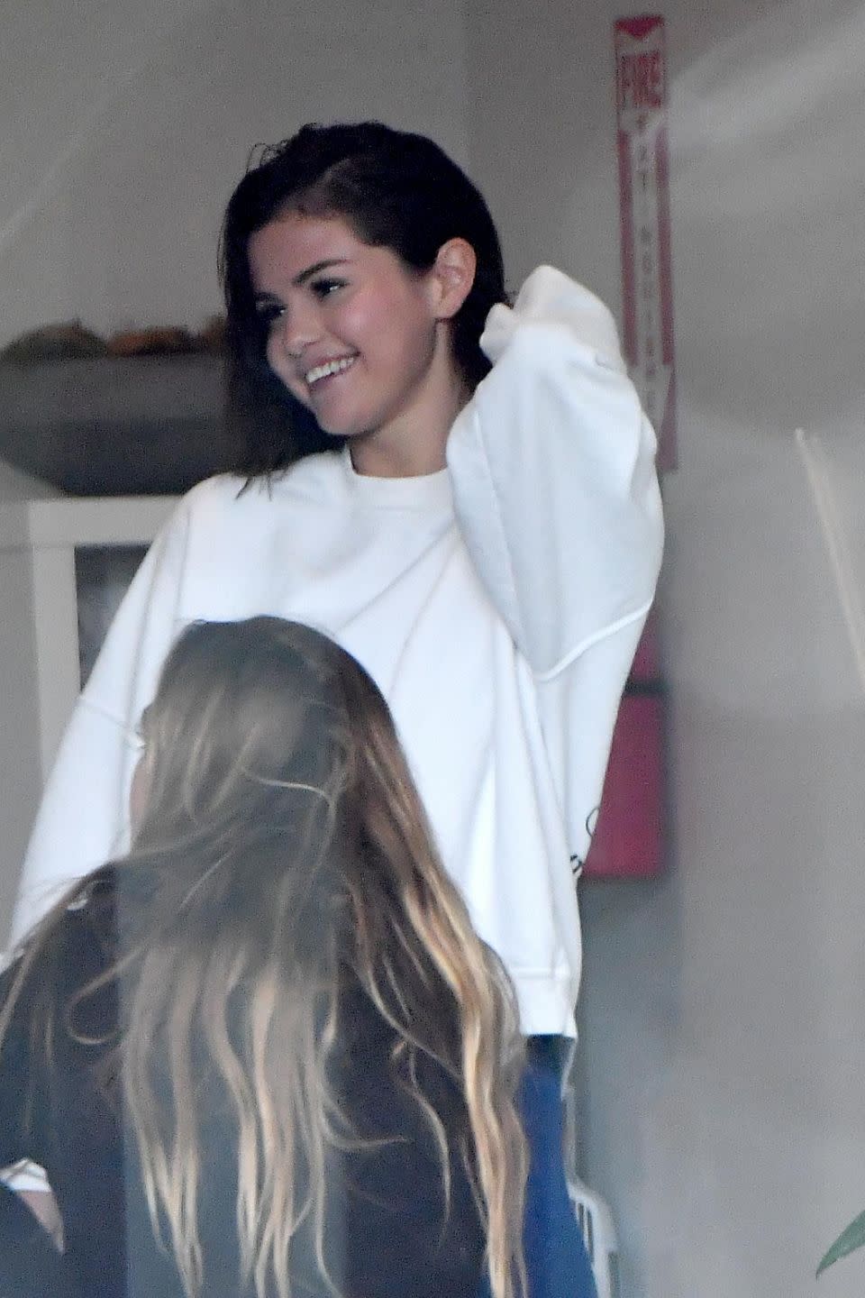 Selena was all smiles after finishing her sweaty workout with Biebs and stopped to chat with fellow classmates. Source: Backgrid