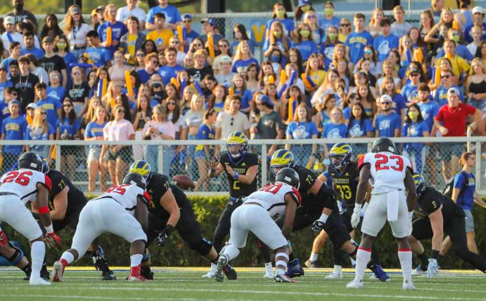 Delaware quarterback Nolan Henderson takes a first quarter snap before a full student section in Delaware's home opener against St. Francis at Delaware Stadium Saturday, Sept. 11, 2021.