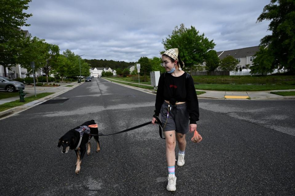 Logan takes out their emotional support dog Dwayne (Reuters)