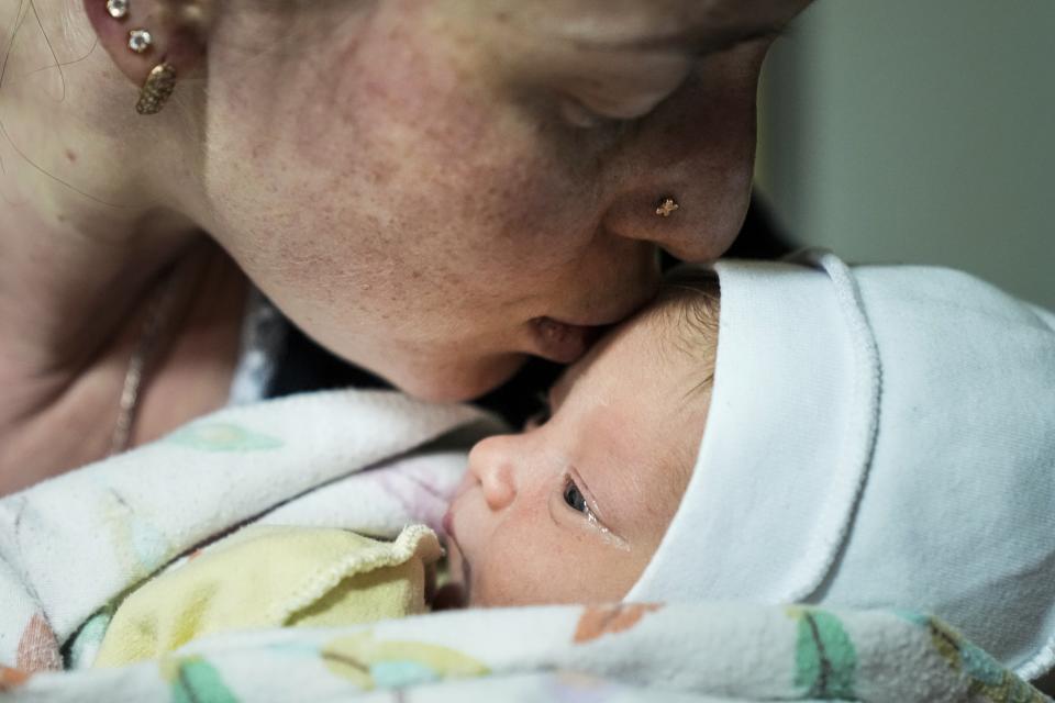 Kateryna Suharokova kisses her newborn son Makar in the basement of a maternity hospital converted into a medical ward and used as a bomb shelter in Mariupol, Ukraine, Monday, Feb. 28, 2022. In makeshift shelters and underground railway platforms across Ukraine, families trying to protect the young and old and make conditions bearable amid the bullets, missiles and shells outside. (AP Photo/Evgeniy Maloletka)