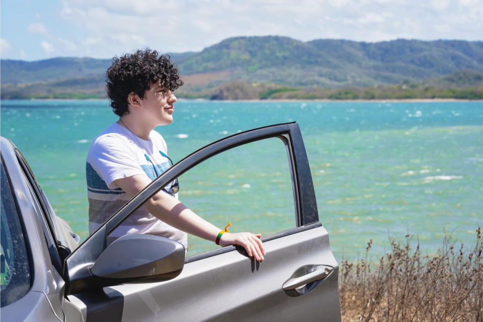 person getting out of their car by the ocean