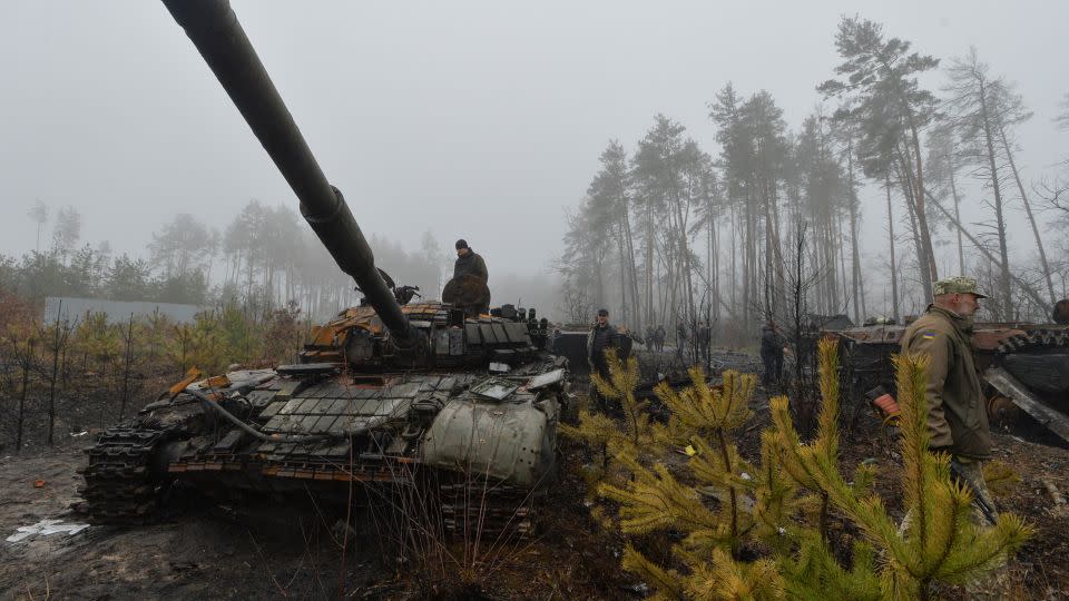 Ukrainian service members and locals inspect destroyed Russian military vehicles, as Russia's attack on Ukraine continues, in the village of Dmytrivka in Kyiv region, Ukraine April 1, 2022. - Oleksandr Klymenko/Reuters