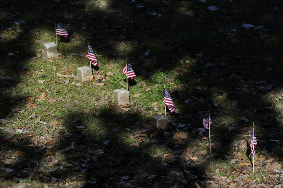 Small American flags stand by the graves of Civil War soldiers of the United States 1st Mississippi Infantry (African Descent) in Vicksburg National Cemetery, Feb. 14, 2024, in Vicksburg, Miss. Thirteen flags were placed at the graves of the Black soldiers killed in an 1864 massacre at Ross Landing, Arkansas, who were buried as unknowns but have recently been identified. (AP Photo/Rogelio V. Solis)