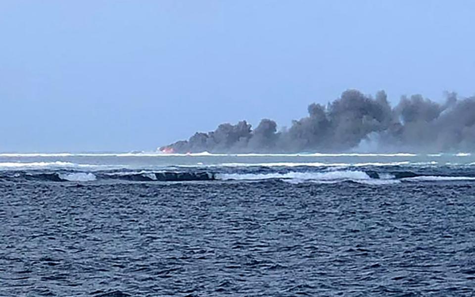 The naval ship ran aground on a reef in rough seas and strong winds on Saturday and the next day caught fire and sank