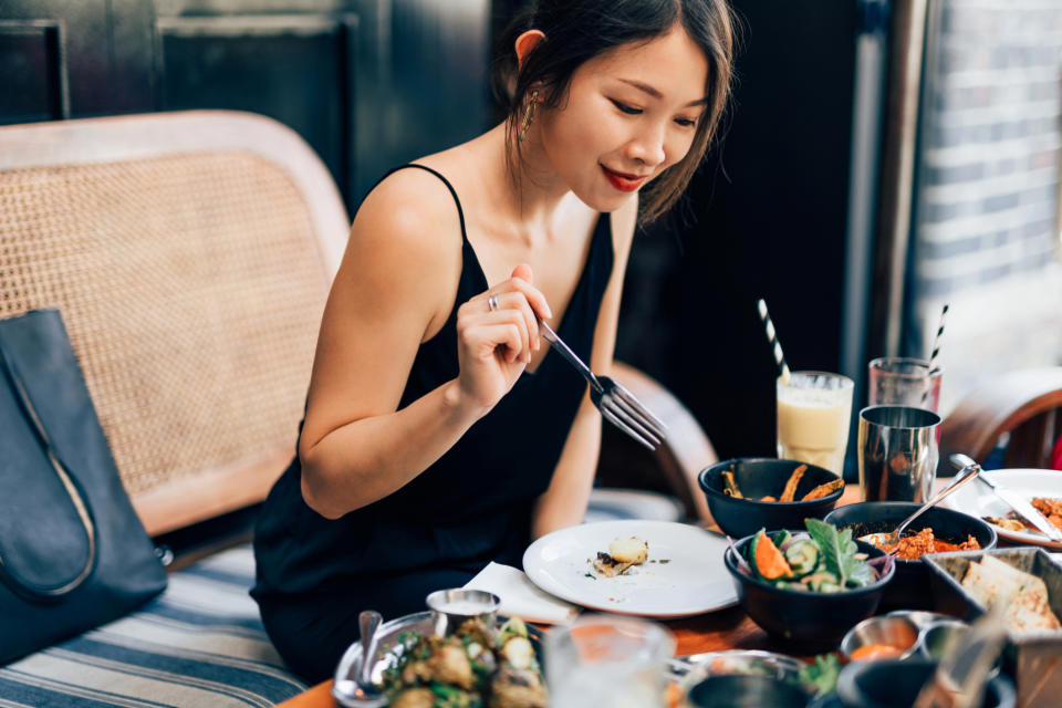 A woman eating in a restaurant by herself