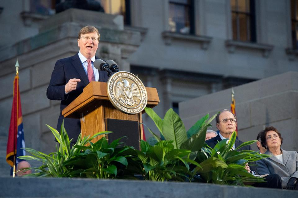 Gov. Tate Reeves delivers the State of the State address on the south steps of the Mississippi State Capitol on Monday. Lt. Governor Delbert Hosemann sits second from right.