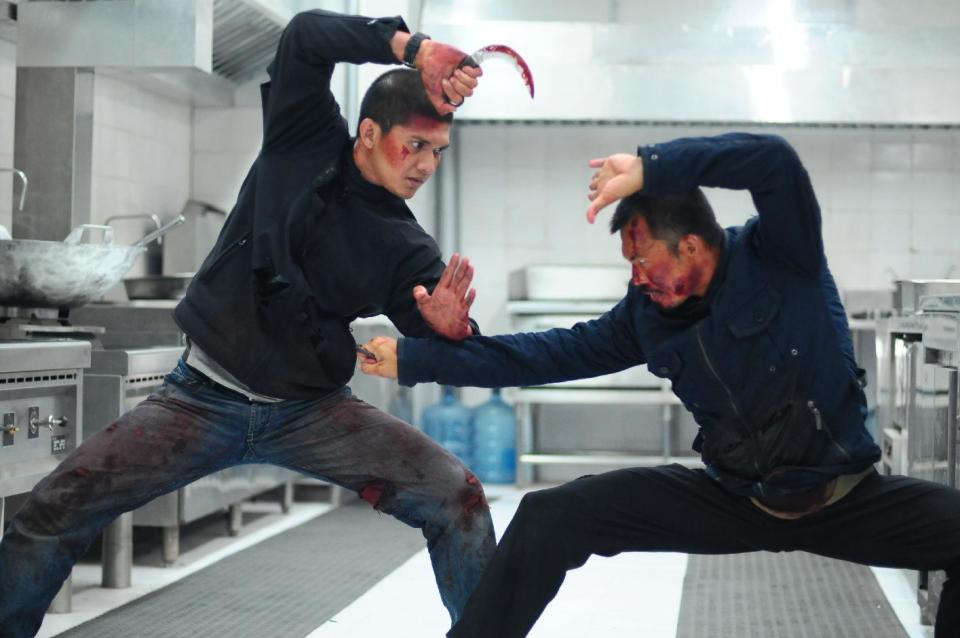 This image released by Sony Pictures Classics shows Iko Uwais, left, and Cecep Arif Rahman in a scene from "The Raid 2." (AP Photo/Sony Pictures Classics)