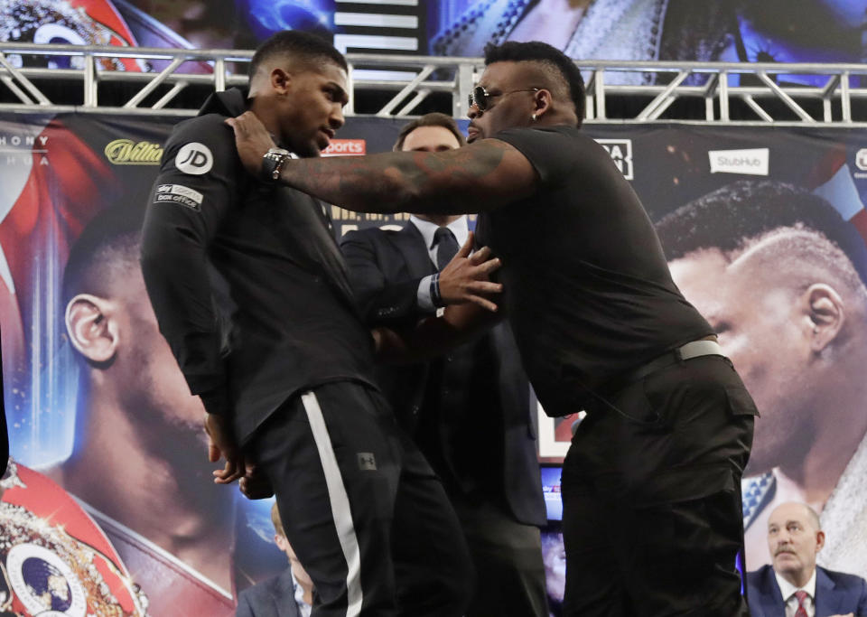 Tuesday’s title fight promotion was a delightful mix of drug accusations, mom insults and shoving between Anthony Joshua and Jarrell Miller. (AP)