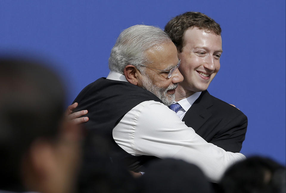 FILE - In this Sept. 27, 2015, file photo, Facebook CEO Mark Zuckerberg, right, hugs Prime Minister of India Narendra Modi at Facebook in Menlo Park, Calif. Officials say a sweeping internet law, announced in February, that puts digital platforms like Twitter and Facebook under direct government oversight are needed to quell misinformation and hate speech and to give users more power to flag objectionable content. Critics of the law worry it may lead to outright censorship in a country where digital freedoms have been shrinking since Modi took office in 2014, many calling it “digital authoritarianism." Facebook’s WhatsApp, which has more than 500 million users in India, has sued the government, saying breaking encryption, which continues for now, would “severely undermine the privacy of billions of people who communicate digitally.” (AP Photo/Jeff Chiu, File)