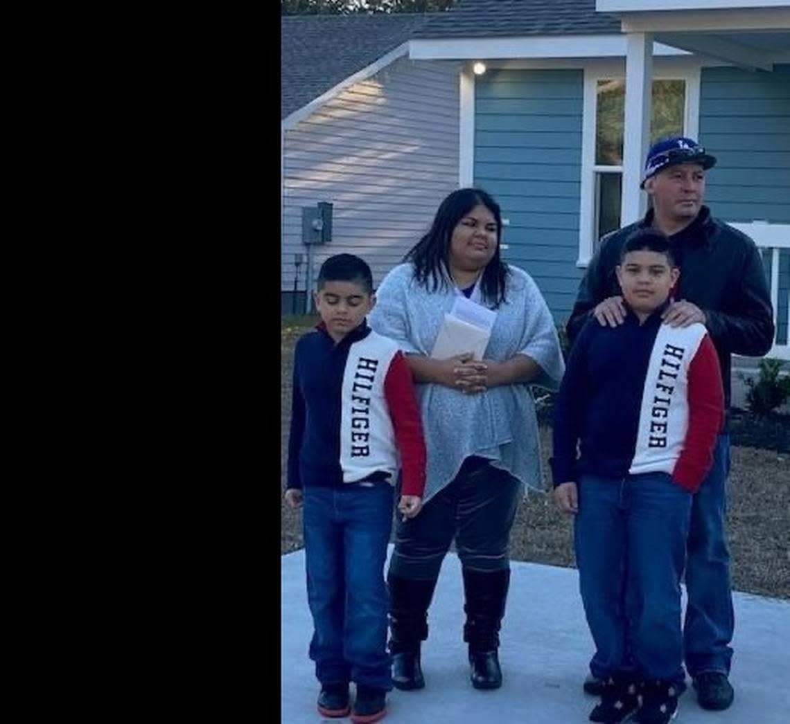 Esmeralda Preciado (back left) and her husband, Douglas Vallejos (back right), stand with their children, William and Matthew. Esmeralda said the family’s new home is “life changing” for her sons.