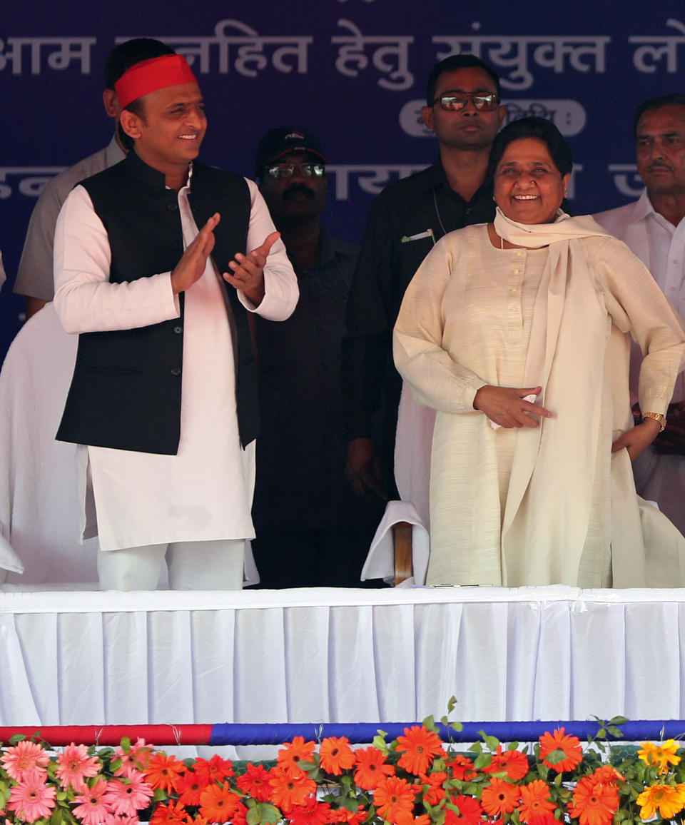 Bahujan Samaj Party (BSP) leader Mayawati, right, and Samajwadi Party (SP) leader Akhilesh Yadav, share the stage during an election rally in Deoband, Uttar Pradesh, India, Sunday, April 7, 2019. Political archrivals in India's most populous state rallied together Sunday, asking voters to support a new alliance created with the express purpose of defeating Prime Minister Narendra Modi's ruling Hindu nationalist Bharatiya Janata Party. (AP Photo/Altaf Qadri)