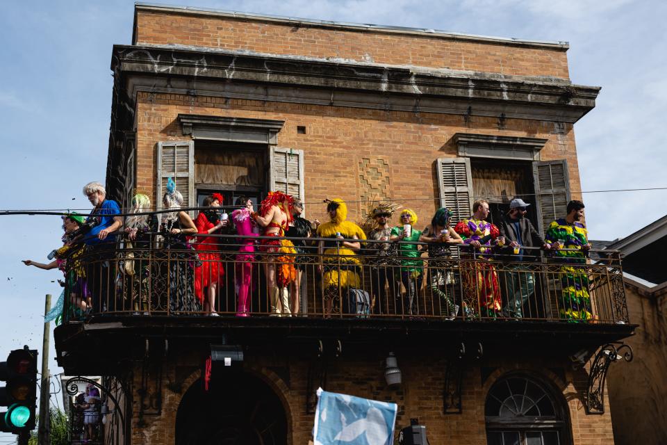 Mardi Gras attendees look out over the St. Anne Parade on Feb. 21, 2023, in New Orleans, Louisiana. Fat Tuesday marks the last day of Carnival season, where costumed attendees flock to multiple parades and parties citywide.