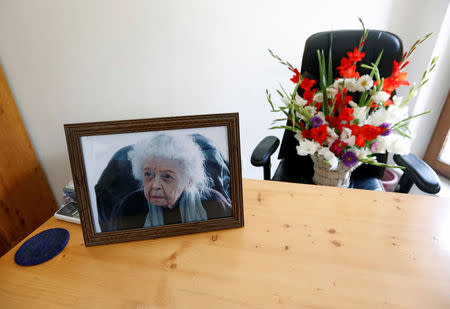 A photograph of late Nancy Hatch Dupree, an American historian, and a bouquet of flowers are seen in her office after she passed away, in Afghanistan Centre at Kabul University (ACKU), in Kabul, Afghanistan September 10, 2017.REUTERS/Mohammad Ismail