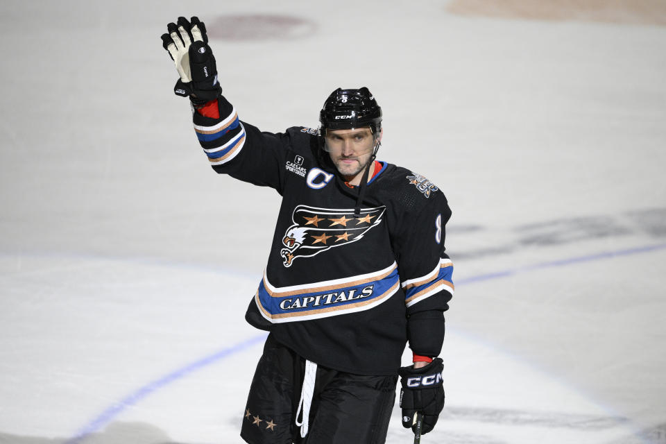 Washington Capitals left wing Alex Ovechkin (8) waves as he continues to celebrate his goal during the third period of an NHL hockey game against the Winnipeg Jets, Friday, Dec. 23, 2022, in Washington. It was Ovechkin's 802nd NHL goal. (AP Photo/Nick Wass)