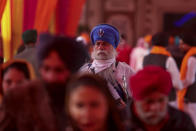 Sikh devotees, arrive to offer prayers during celebrations to mark the birth anniversary of the first Sikh Guru, Guru Nanak Dev, at a Gurudwara, or Sikh temple, in Jammu, India, Monday, Nov.30, 2020. India is second behind the U.S. in total coronavirus cases. Its recovery rate is nearing 94%. (AP Photo/Channi Anand)