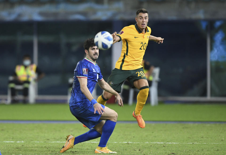 Australia's Chris Ikonomidis, right, attempts a head at goal in front of Kuwait's Khaled Ibrahim during the World Cup 2022 Group B qualifying soccer match between Kuwait and Australia in Kuwait City, Kuwait, Thursday, June 3, 2021. (AP Photo/Jaber Abdulkhaleg)