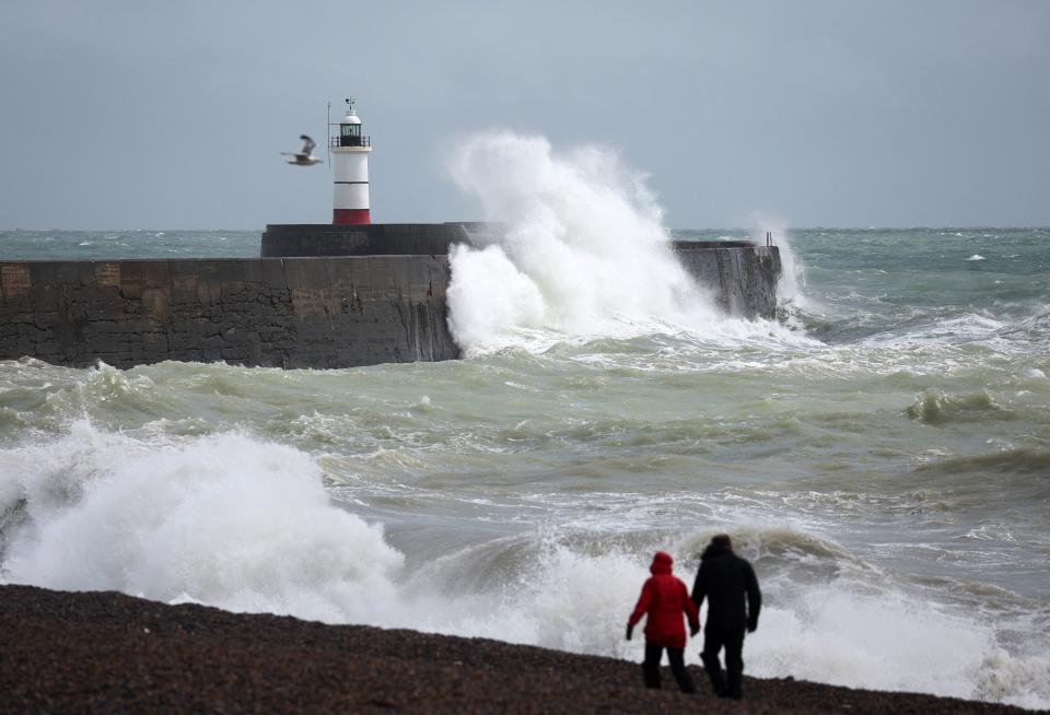 Waves crash over the breakwater by Newhaven Lighthouse on August 5, 2023, as Storm Antoni brings rain and high winds to the UK. (Photo by HENRY NICHOLLS / AFP) (Photo by HENRY NICHOLLS/AFP via Getty Images)