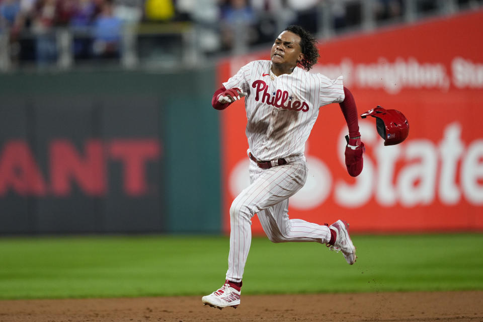 Philadelphia Phillies' Cristian Pache heads to third before scoring on a double by Kyle Schwarber against the Miami Marlins during the third inning of Game 2 in an NL wild-card baseball playoff series Wednesday, Oct. 4, 2023, in Philadelphia. (AP Photo/Matt Rourke)