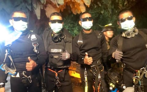 The last four Thai Navy Seals giving a thumbs up after exiting safely from the Tham Luang cave on Tuesday - Credit:  AFP