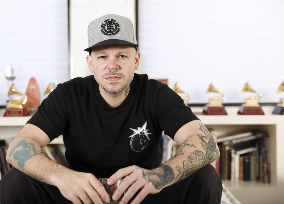 This July 12, 2019 photo shows Puerto Rican rapper, writer, and filmmaker René Pérez Joglar, known professionally as Residente, at his home in New York. Residente studied intensely with professors at Yale University and New York University to create his second solo project. The untitled album will be released in November. (Photo by Brian Ach/Invision/AP)