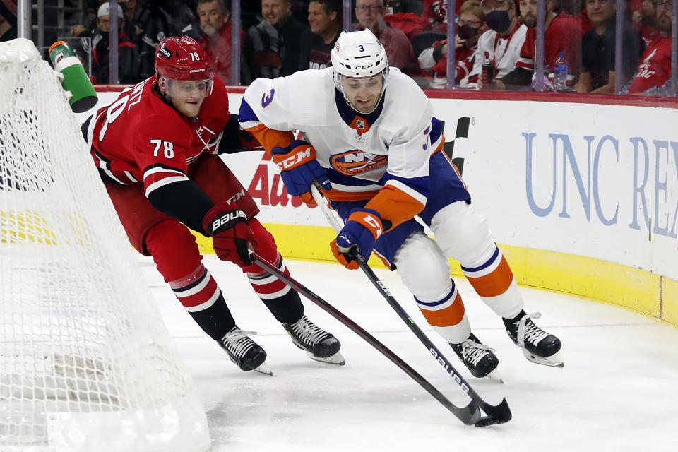 Carolina Hurricanes' Steven Lorentz (78) reaches for the puck controlled by New York Islanders' Adam Pelech (3) during the second period of an NHL hockey game in Raleigh, N.C., Thursday, Oct. 14, 2021. (AP Photo/Karl B DeBlaker)