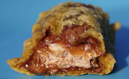 A deep fried Mars bar is seen at the Golden Arrow fish, chips and chicken bar in Kilmarnock, Scotland in this March 24, 2014 file photo. REUTERS/Suzanne Plunkett/Files